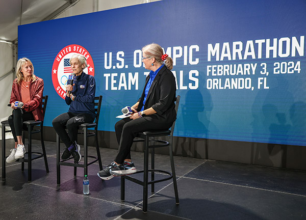 Joan Benoit Samuelson, the 1984 Trials champion and Olympic gold medalist, was flanked by 2004 Olympic bronze medalist Deena Kastor and Betsy Hughes, co-owner of Track Shack and Track Shack Events (TSE), steps from the Florida finish line